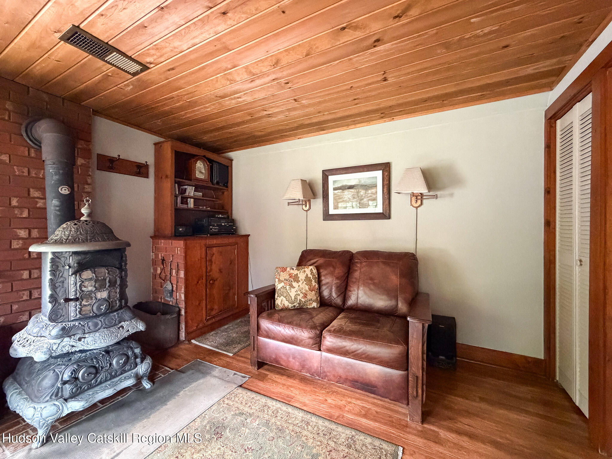 221 Camp Medusa Road Rensselaerville, NY 12120 - Photo 6 of 57 a living room with furniture and a wooden floor