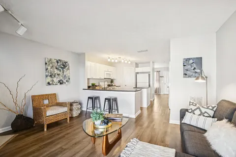 a living room with furniture and wooden floor