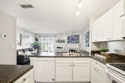 a view of a kitchen cabinets and wooden floor
