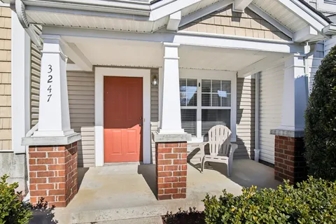 a front view of a house with outdoor seating and covered area