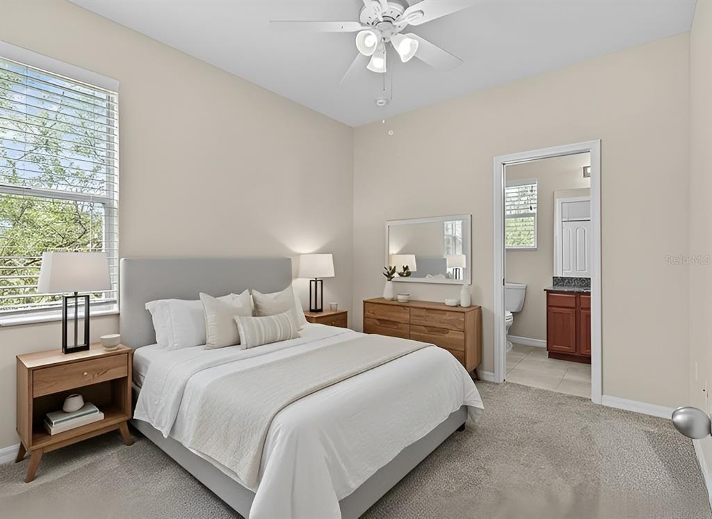 800 Callista Cay Loop Tarpon Springs, FL 34689 - Photo 26 of 36 a bedroom with a large bed and a chandelier