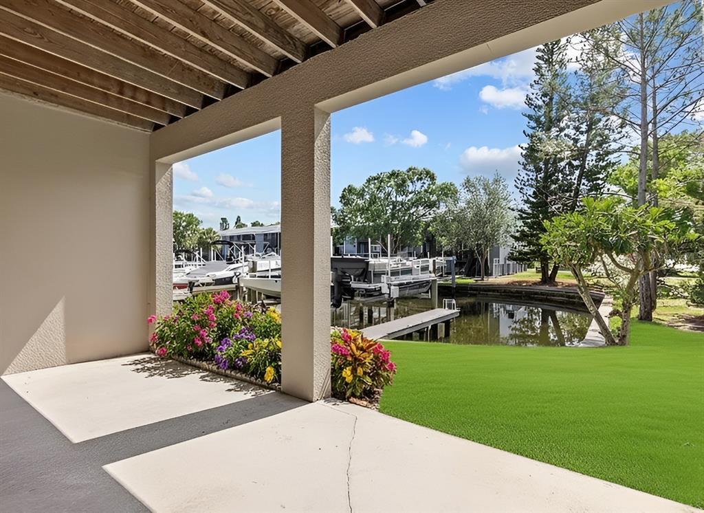800 Callista Cay Loop Tarpon Springs, FL 34689 - Photo 36 of 36 a view of a porch with furniture and garden