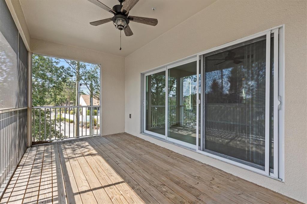 800 Callista Cay Loop Tarpon Springs, FL 34689 - Photo 9 of 36 a view of a room with wooden floor and balcony