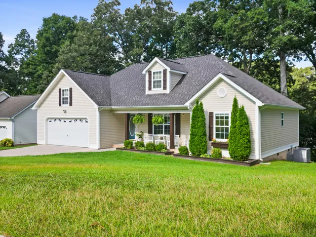 a front view of a house with a yard and garage