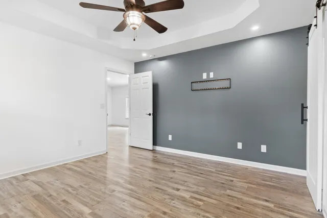 a view of an empty room with wooden floor