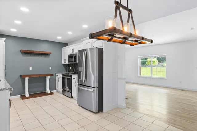 a kitchen with stainless steel appliances a refrigerator and a stove top oven