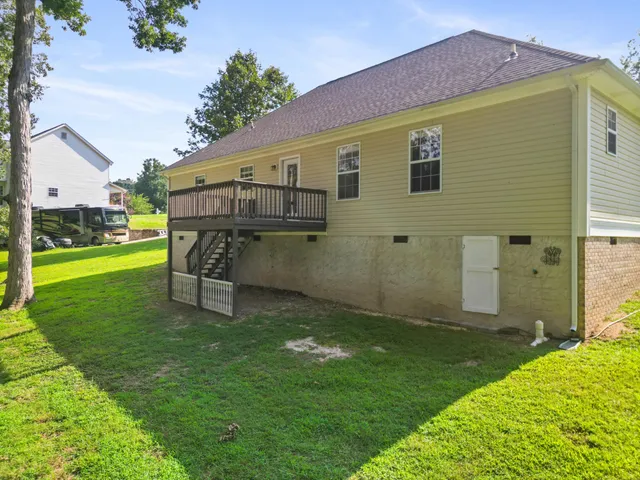 a backyard of a house with table and chairs