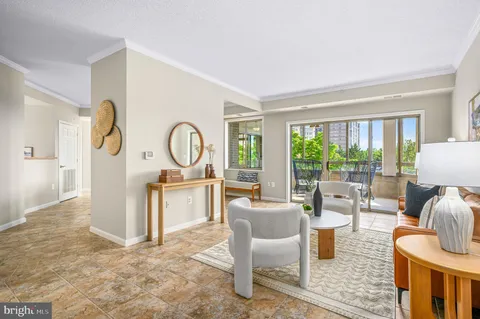a living room with furniture a rug floor and a large window