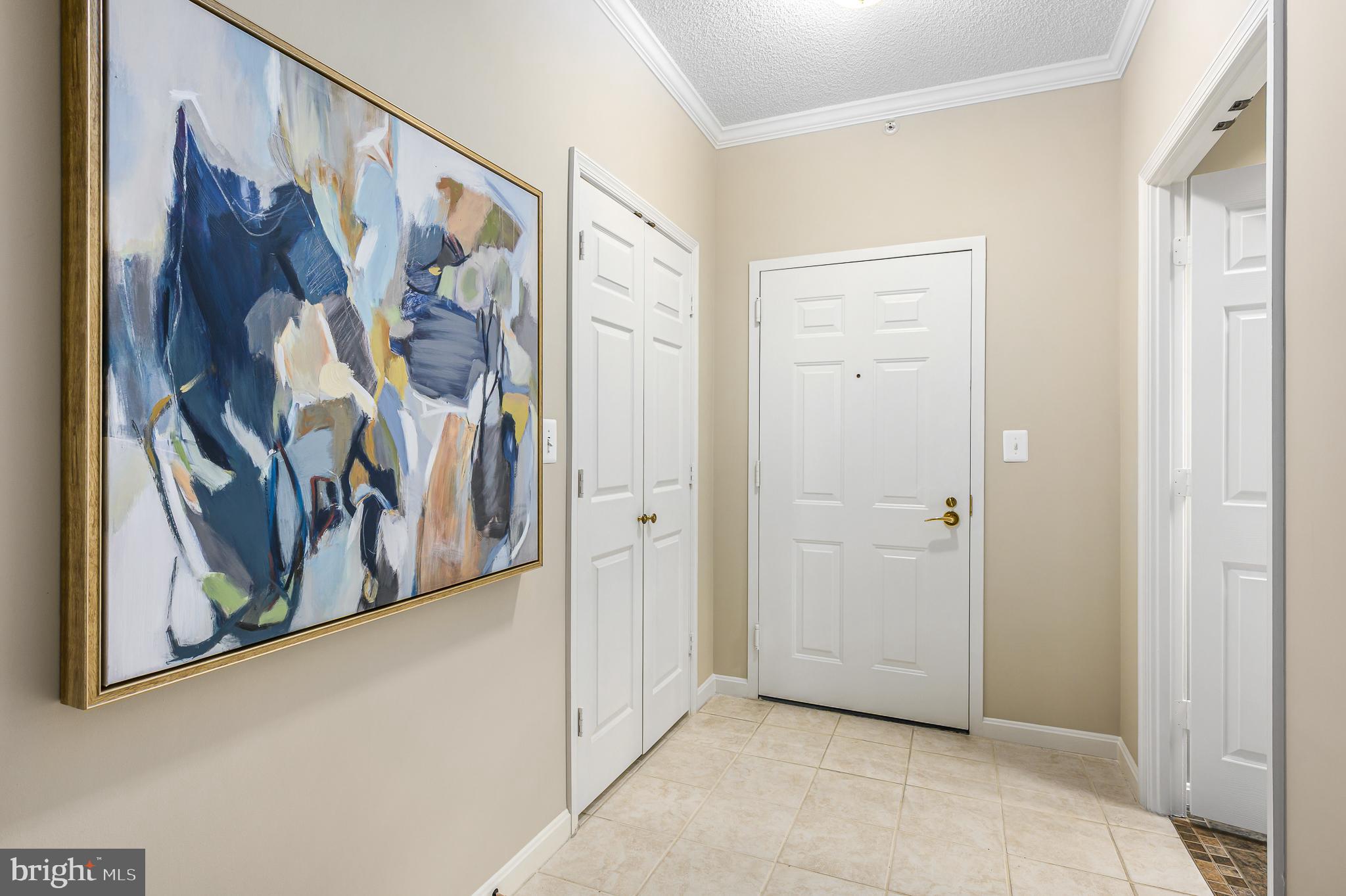 19375 Cypress Ridge Terrace, Unit 114 Leesburg, VA 20176 - Photo 15 of 42 a view of a hallway with paintings on the wall