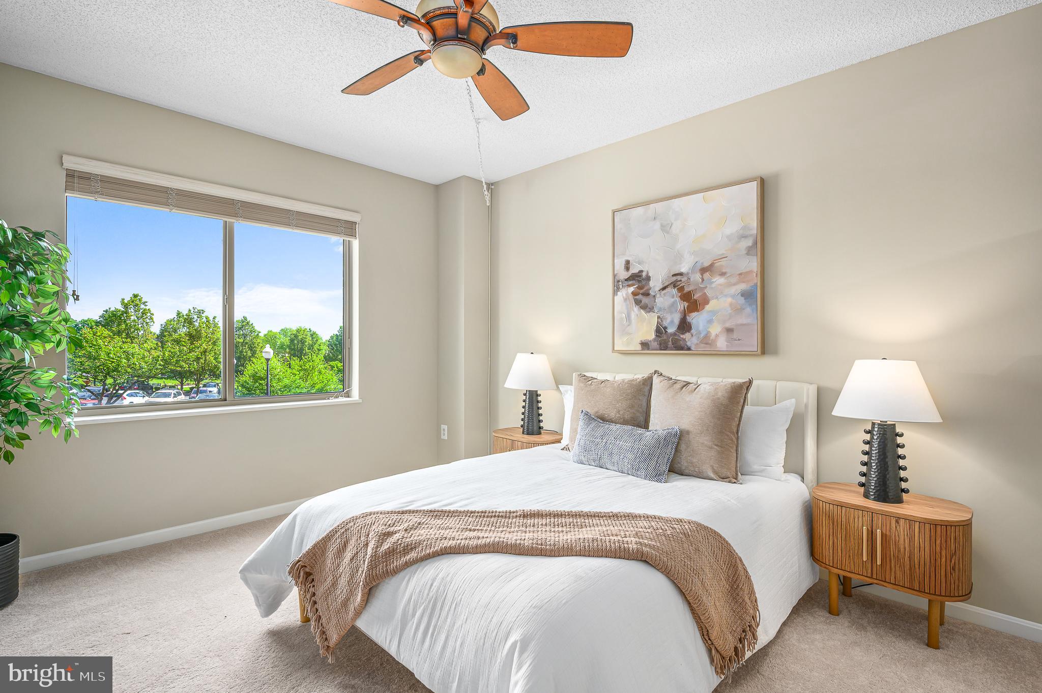 19375 Cypress Ridge Terrace, Unit 114 Leesburg, VA 20176 - Photo 22 of 42 a bedroom with a large bed and a chandelier