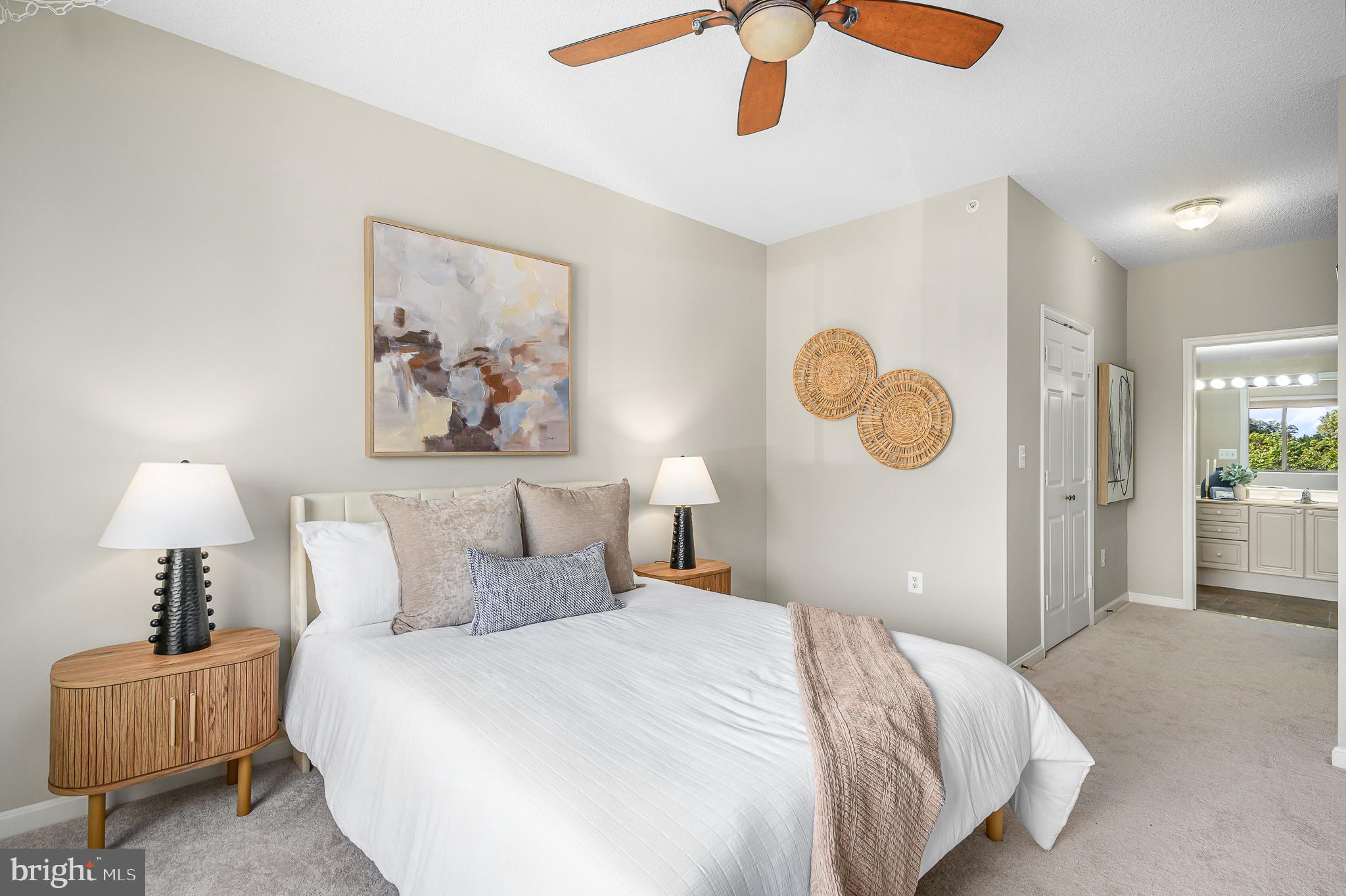 19375 Cypress Ridge Terrace, Unit 114 Leesburg, VA 20176 - Photo 24 of 42 a bedroom with a bed and a chandelier