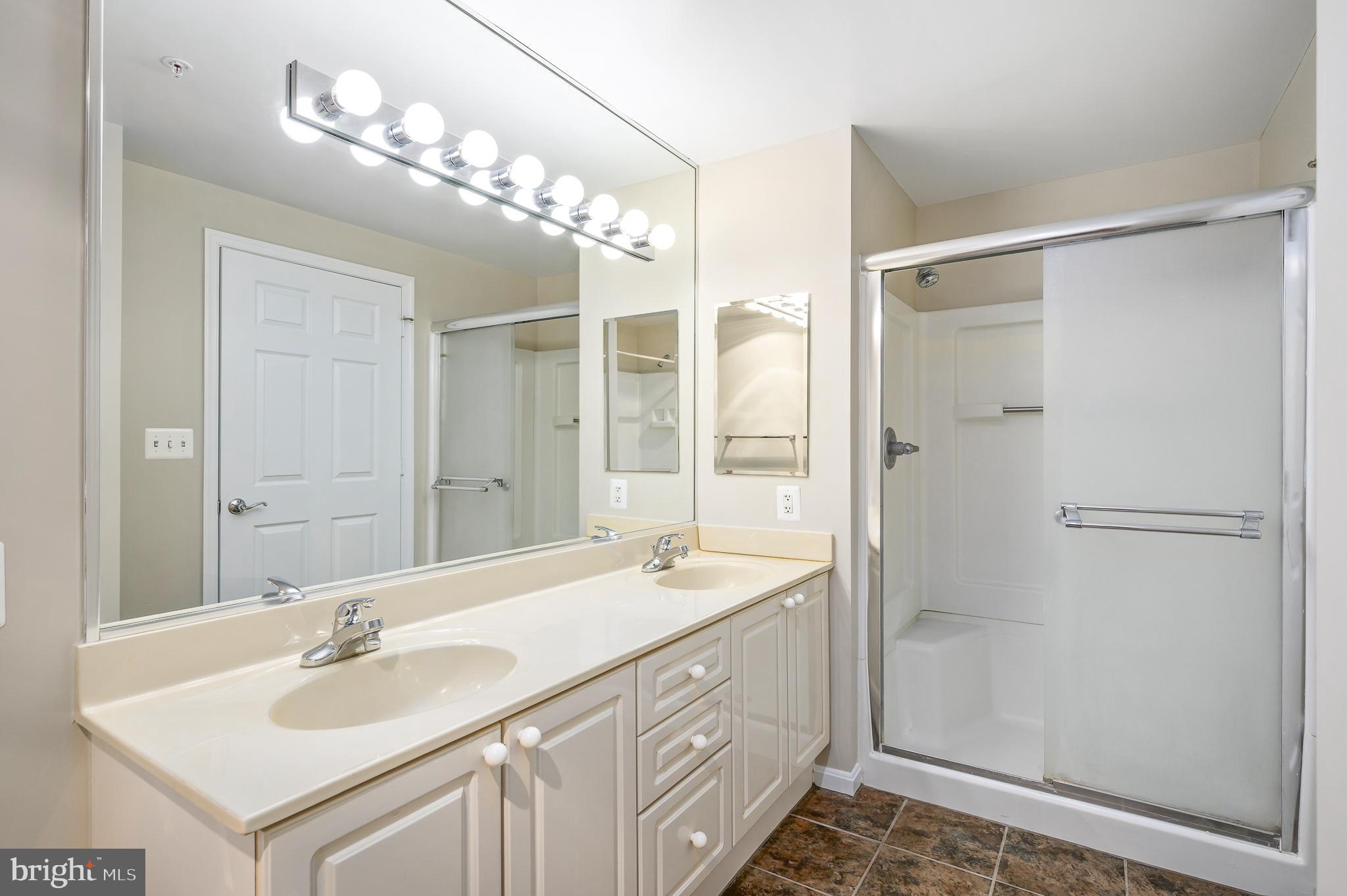 19375 Cypress Ridge Terrace, Unit 114 Leesburg, VA 20176 - Photo 24 of 41 Dual sinks with walk in shower
