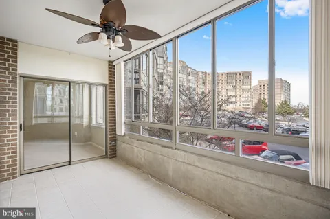 a large kitchen with a large window and cabinets