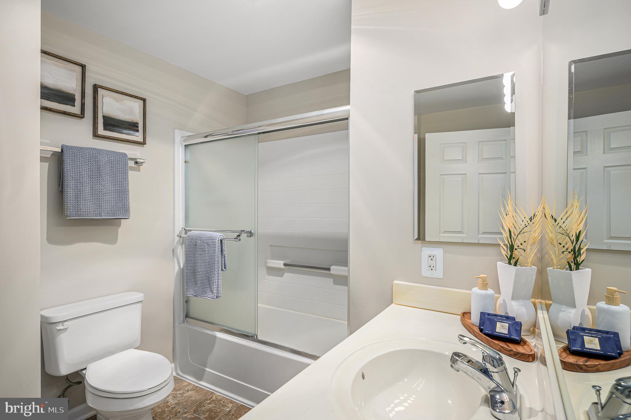 19375 Cypress Ridge Terrace, Unit 114 Leesburg, VA 20176 - Photo 30 of 42 a bathroom with a sink toilet and shower