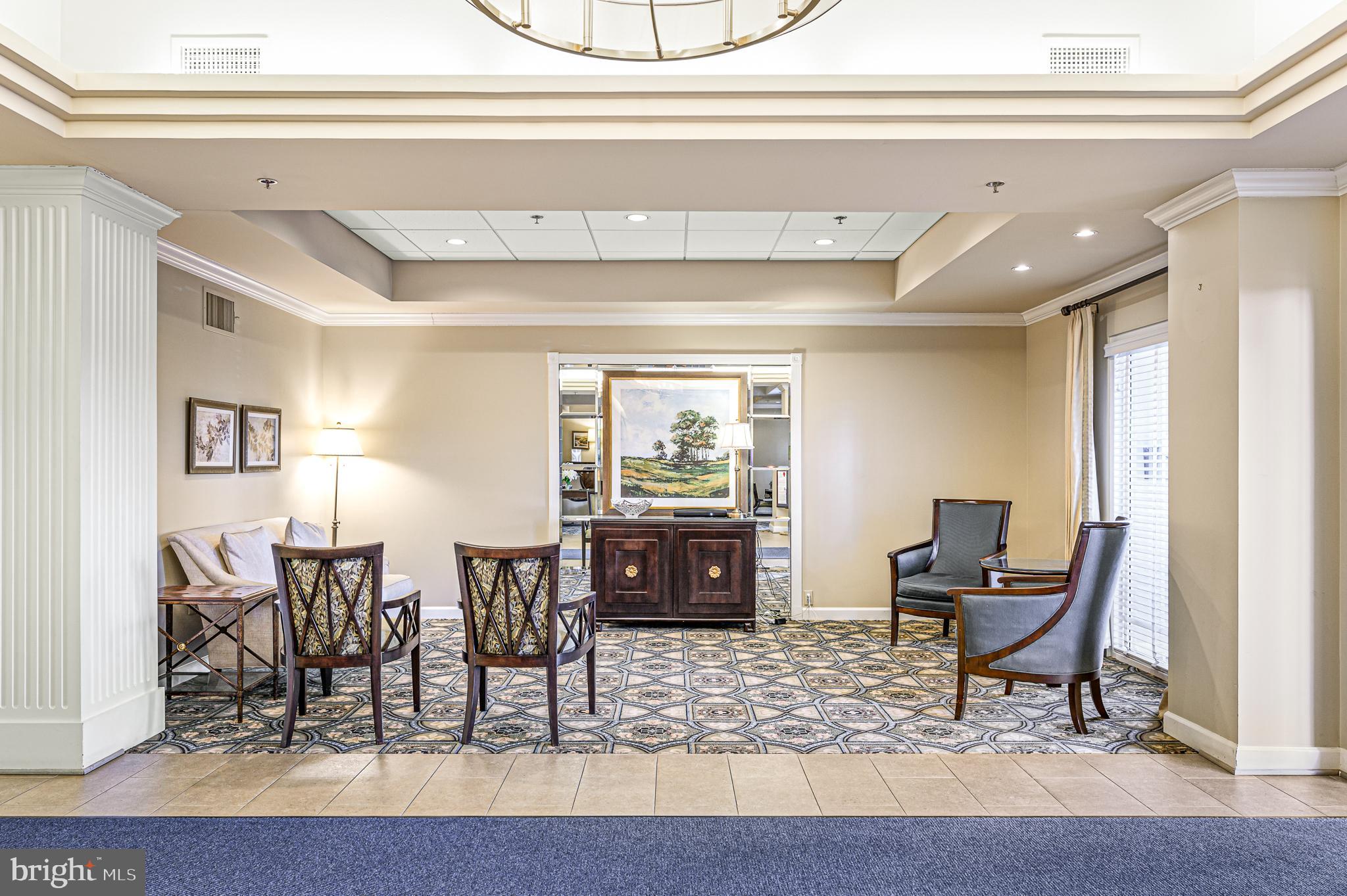 19375 Cypress Ridge Terrace, Unit 114 Leesburg, VA 20176 - Photo 34 of 42 a living room with furniture and wooden floor