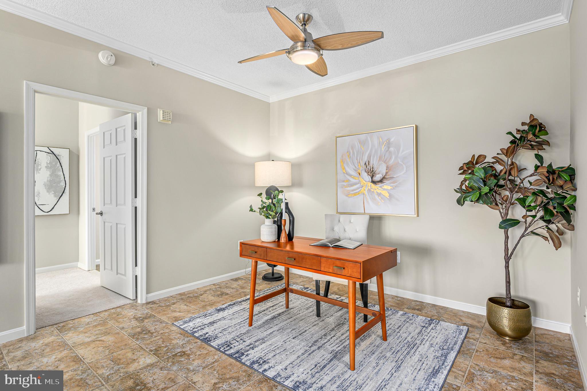 19375 Cypress Ridge Terrace, Unit 114 Leesburg, VA 20176 - Photo 10 of 42 a living room with furniture and a potted plant