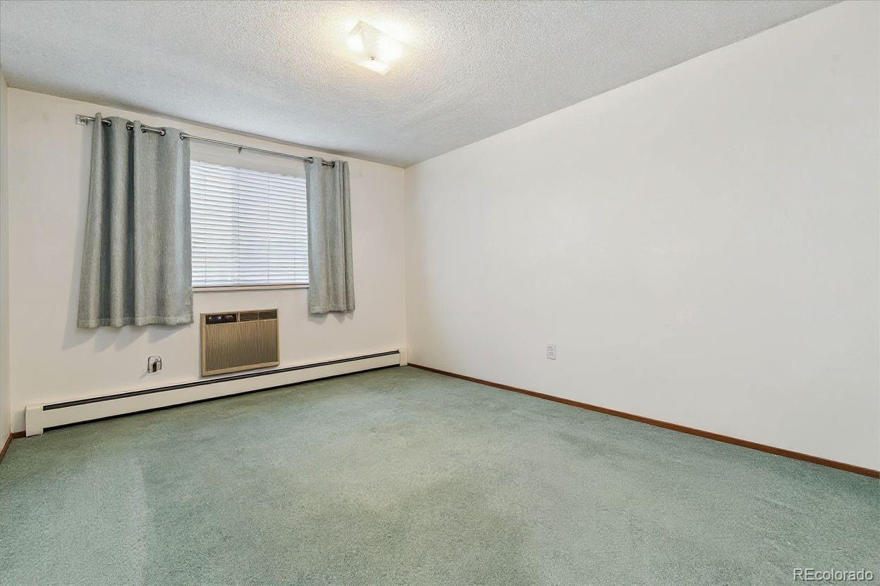 680 South Alton Way, Unit 9B Denver, CO 80247 - Photo 12 of 31 an empty room with a fireplace