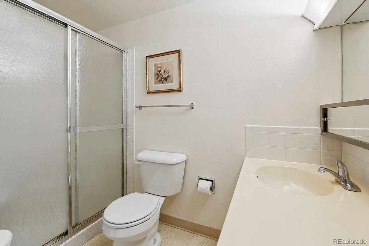 680 South Alton Way, Unit 9B Denver, CO 80247 - Photo 13 of 31 a white toilet sitting next to a bathroom sink