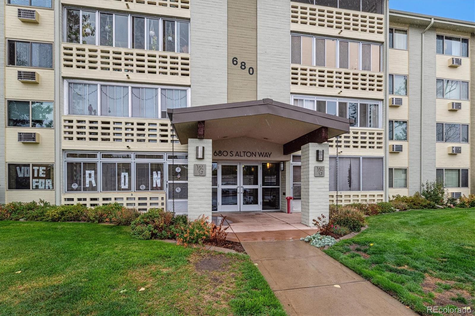 680 South Alton Way, Unit 9B Denver, CO 80247 - Photo 15 of 31 a front view of a residential apartment building with a yard