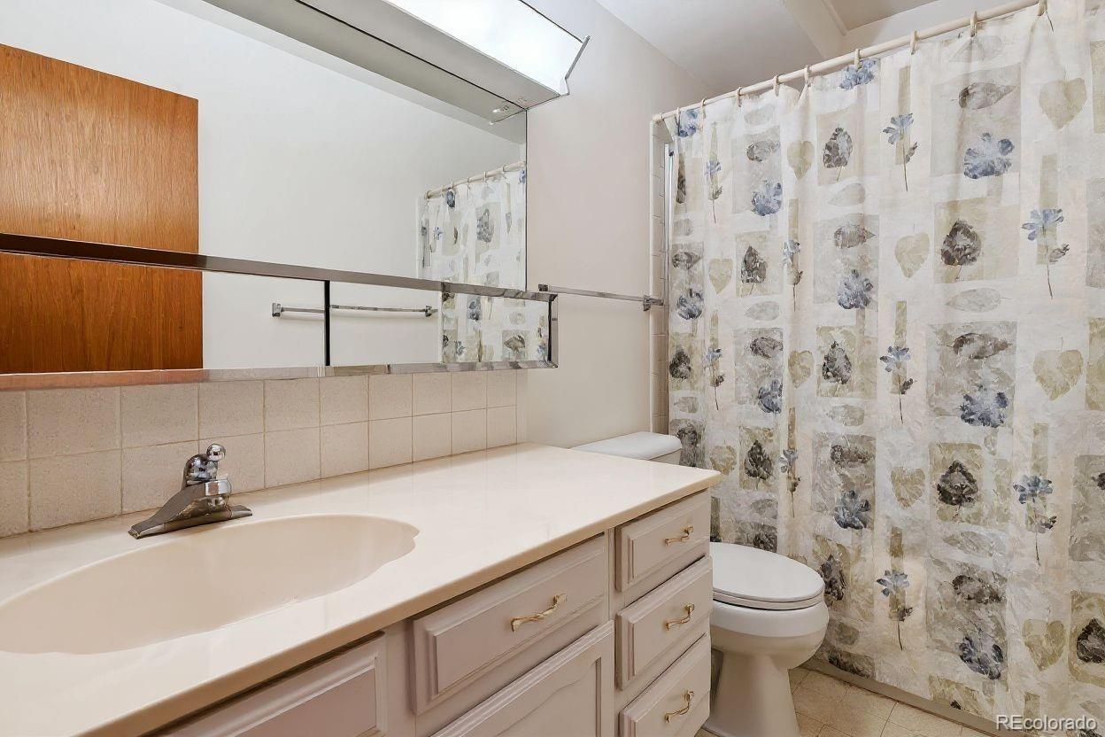 680 South Alton Way, Unit 9B Denver, CO 80247 - Photo 10 of 31 a bathroom with a sink and a toilet