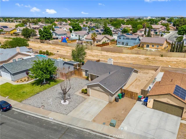 an aerial view of residential houses with outdoor space and street view