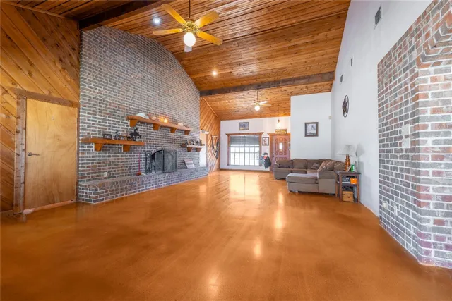 a view of a livingroom with wooden floor and a fireplace