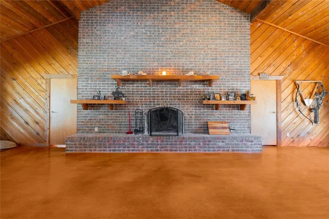 a spacious bedroom with a bed and a chandelier