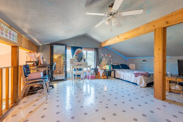 a bathroom with a granite countertop sink a toilet and shower