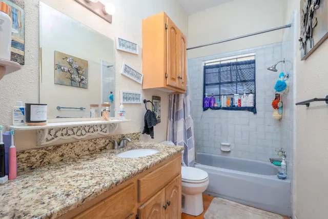 a living room with furniture and a dining table