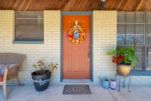 a view of a house with backyard porch and furniture