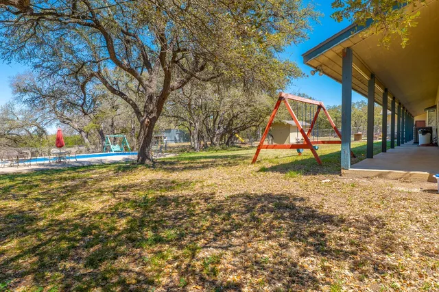 a view of a swimming pool with a table and chairs