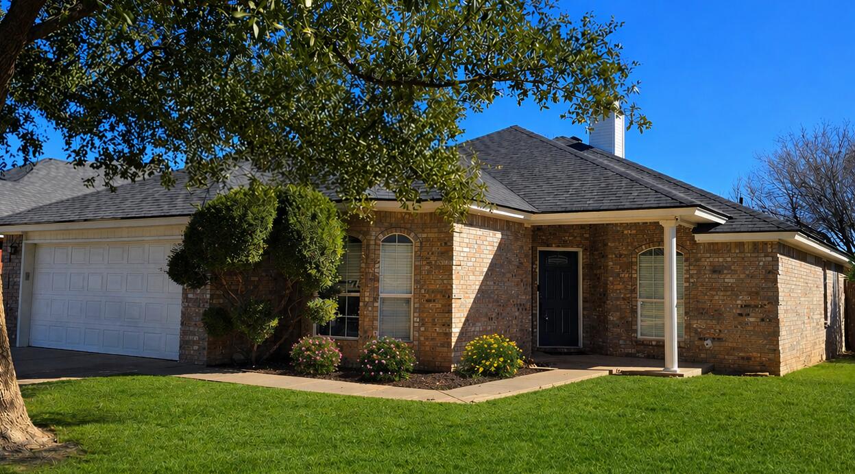 6701 Chicago Avenue Lubbock, TX 79424 - Photo 1 of 35 a view of a house with brick walls and a tree