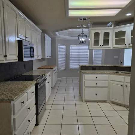 a kitchen with stainless steel appliances granite countertop a sink and a stove