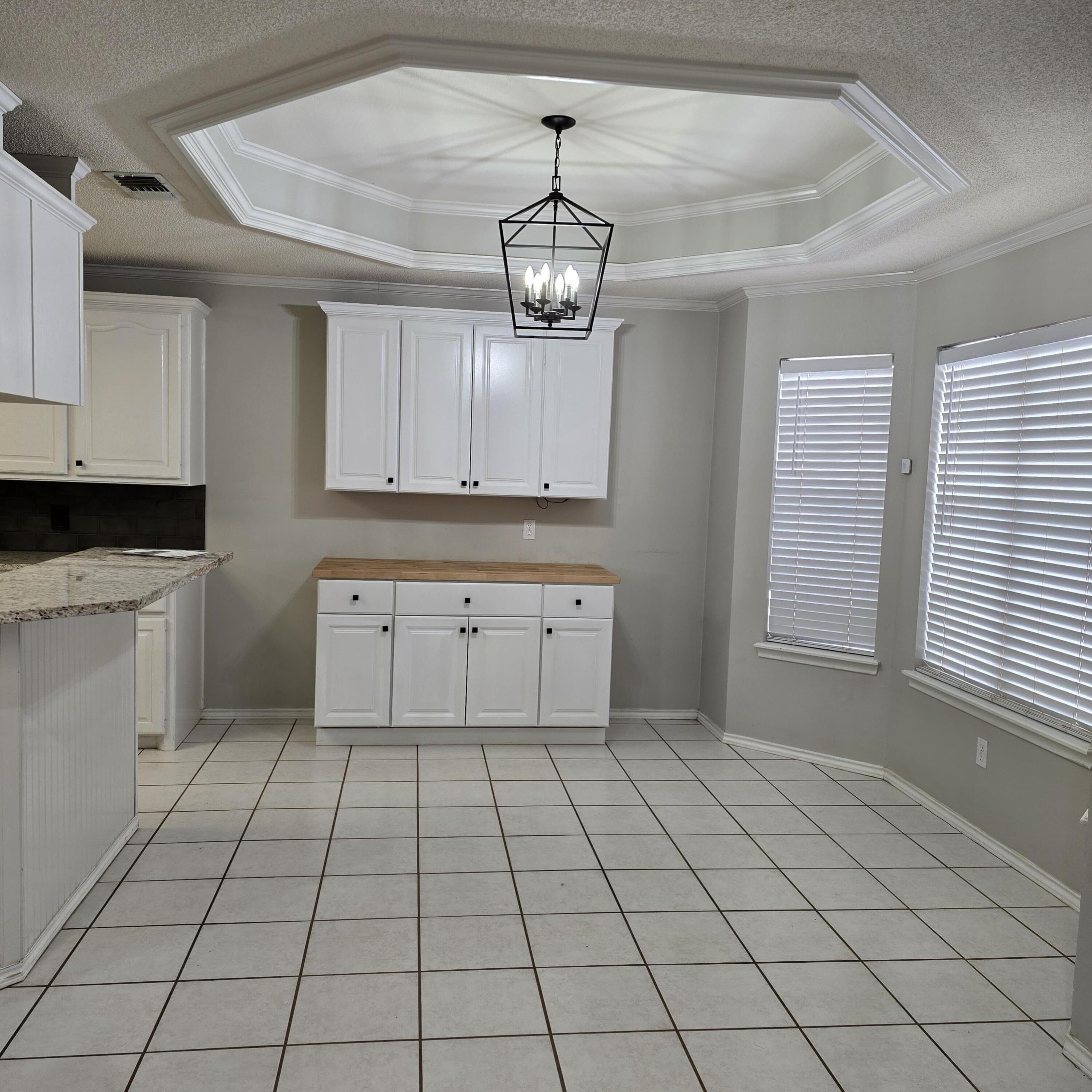 6701 Chicago Avenue Lubbock, TX 79424 - Photo 12 of 35 a kitchen with a sink a stove cabinets and a window