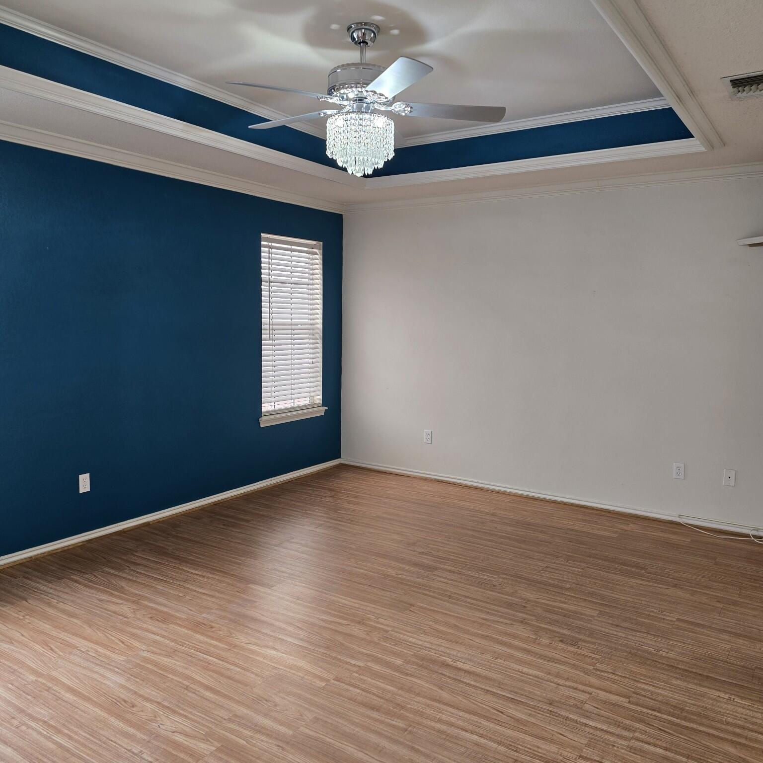 6701 Chicago Avenue Lubbock, TX 79424 - Photo 17 of 35 a view of an empty room with wooden floor and a window