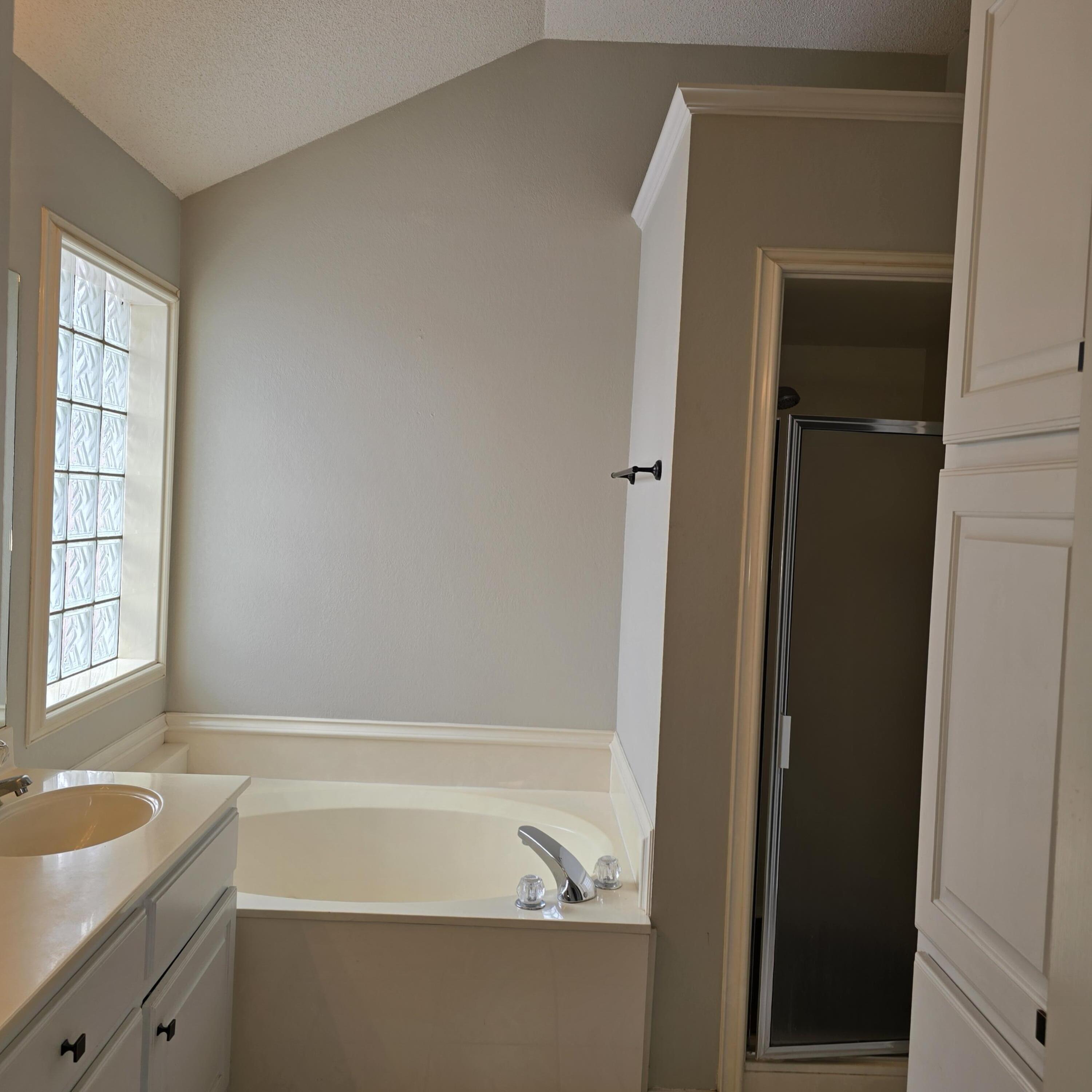 6701 Chicago Avenue Lubbock, TX 79424 - Photo 18 of 35 a bathroom with a tub sink and vanity