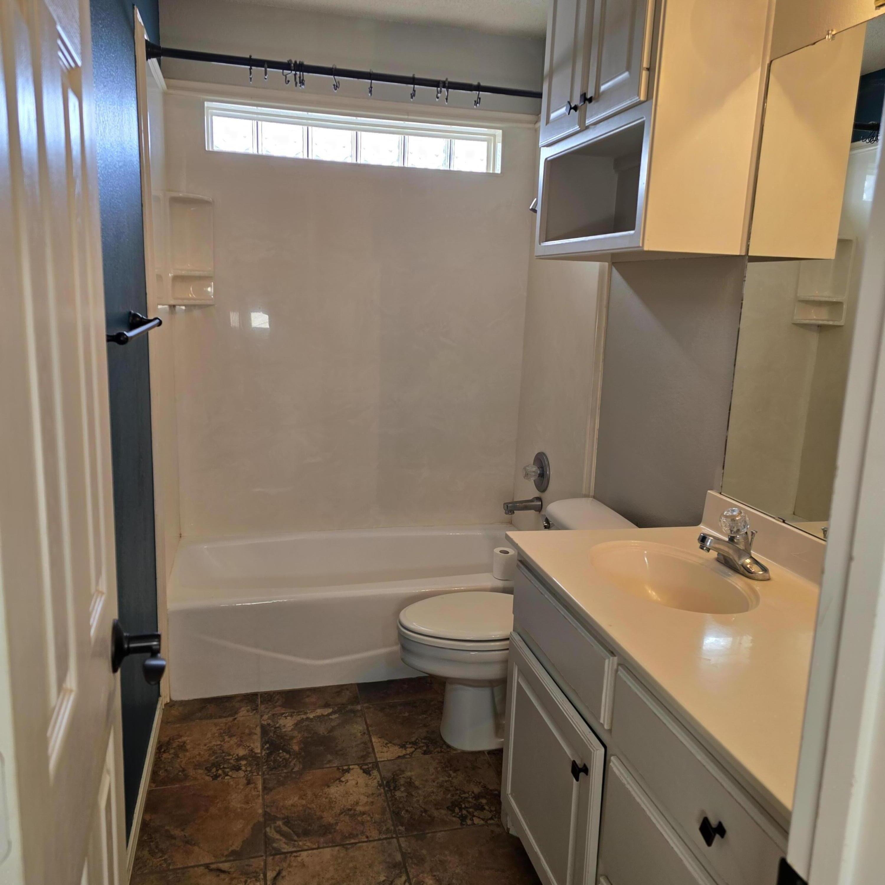6701 Chicago Avenue Lubbock, TX 79424 - Photo 22 of 35 a bathroom with a sink a toilet and shower