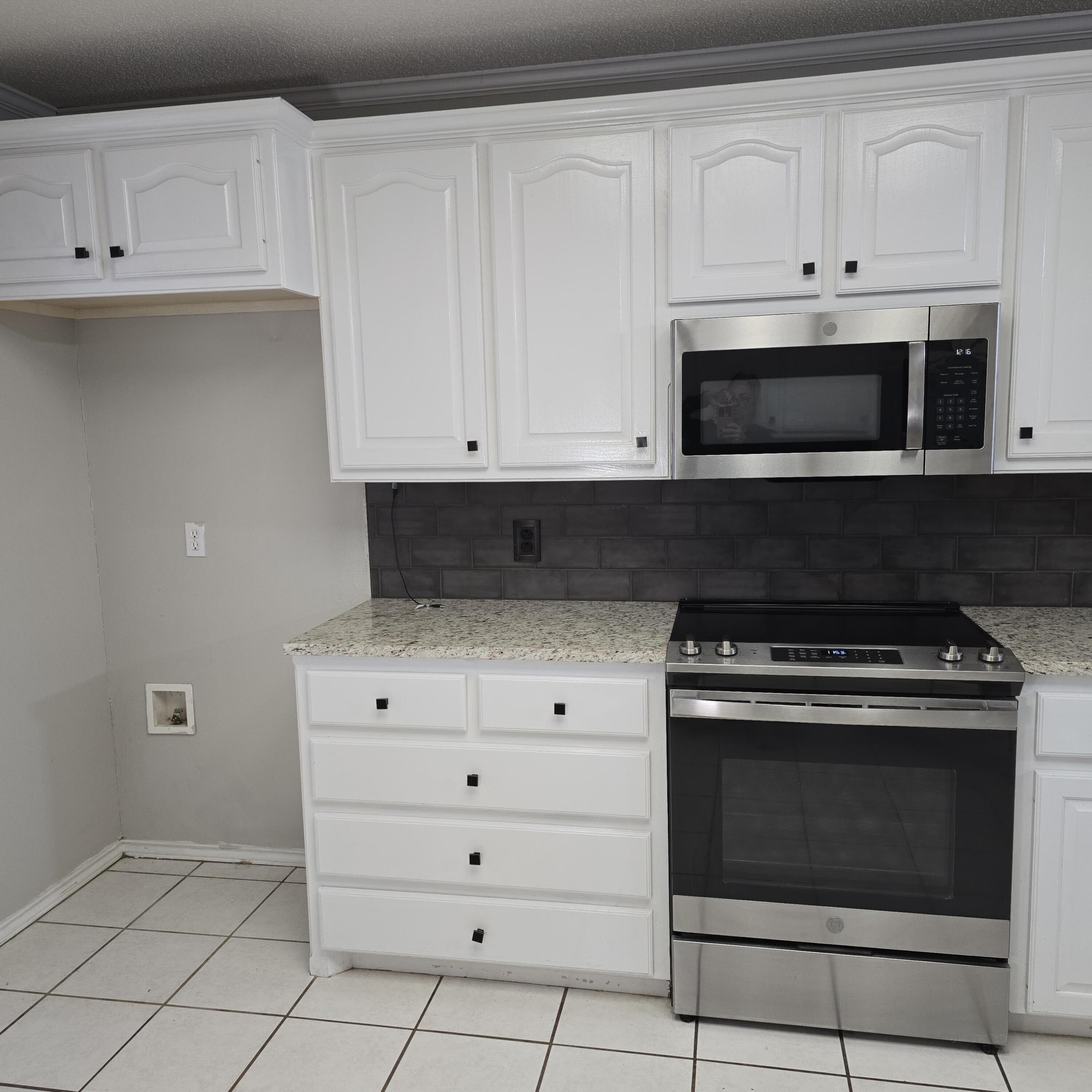6701 Chicago Avenue Lubbock, TX 79424 - Photo 8 of 35 a kitchen with white cabinets and appliances