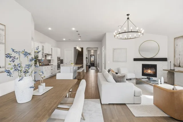 a living room with fireplace furniture and a chandelier