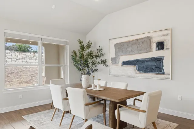 a dining room with furniture and window