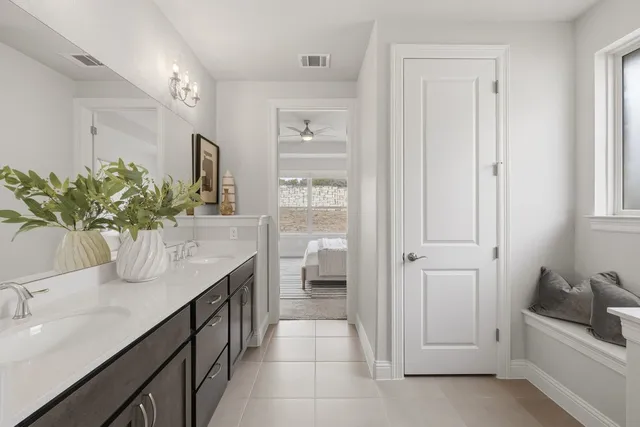 a bathroom with a granite countertop sink a toilet and shower