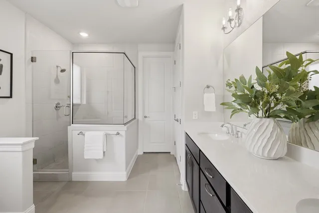 a spacious bathroom with a granite countertop sink a toilet and shower