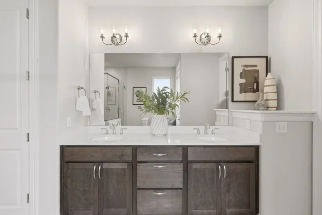 a bathroom with a double vanity sink and a mirror