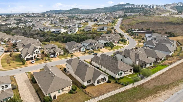 an aerial view of a house with a mountain