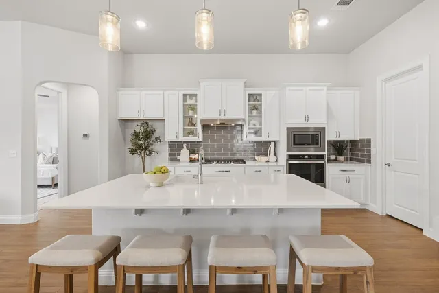 a large kitchen with a table and chairs