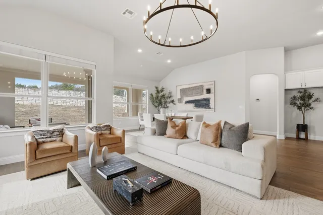 a living room with furniture a fireplace and a large window