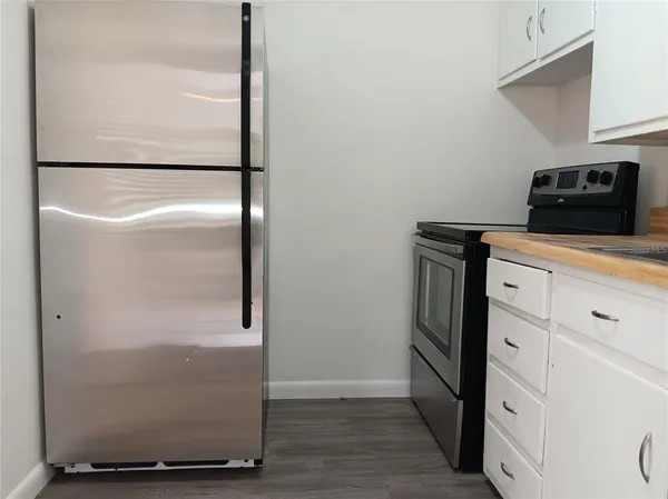a utility room with wooden floor washer and dryer