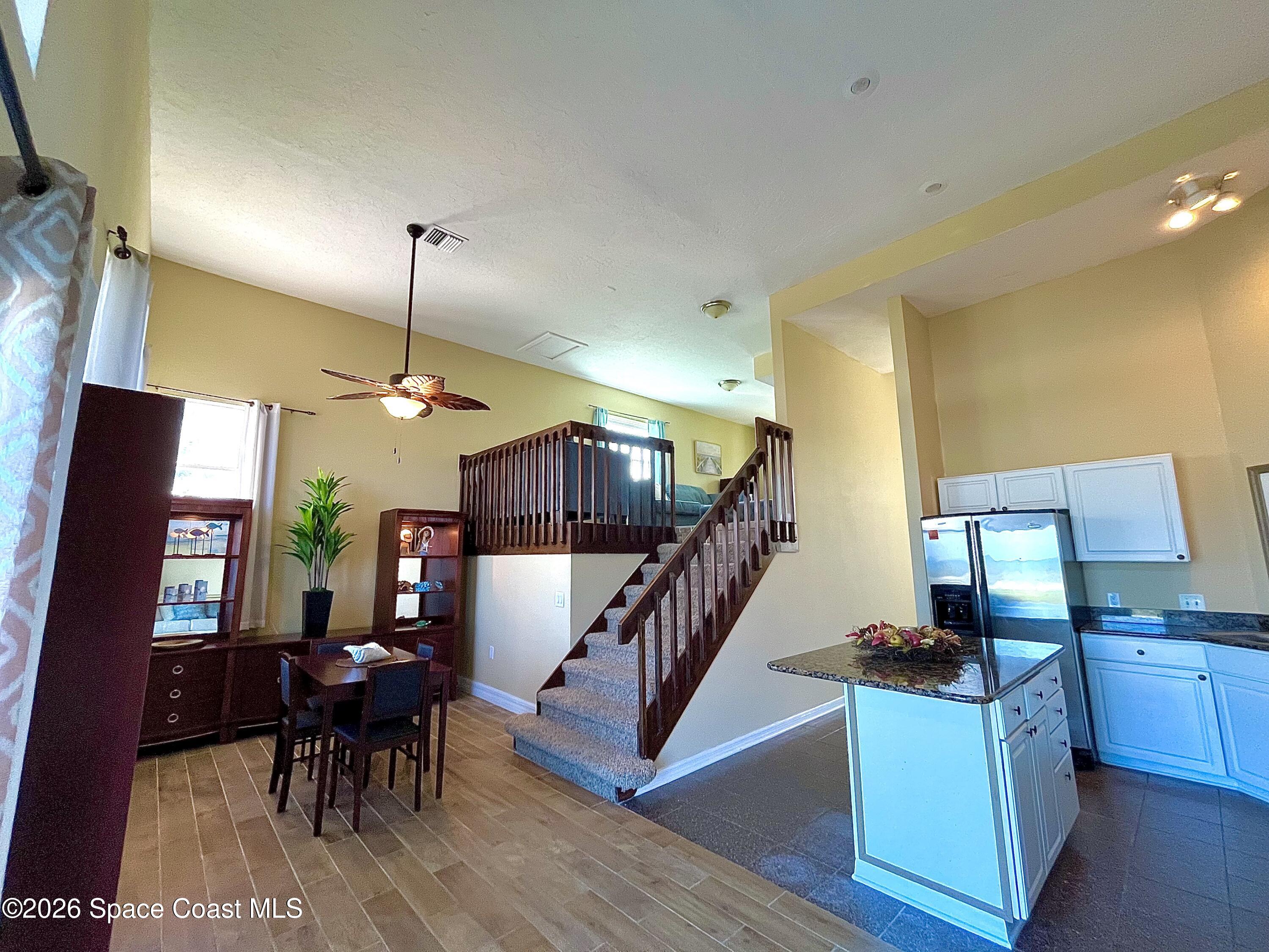799 Shell Street Satellite Beach, FL 32937 - Photo 13 of 32 a view of a dining room with furniture a chandelier and wooden floor