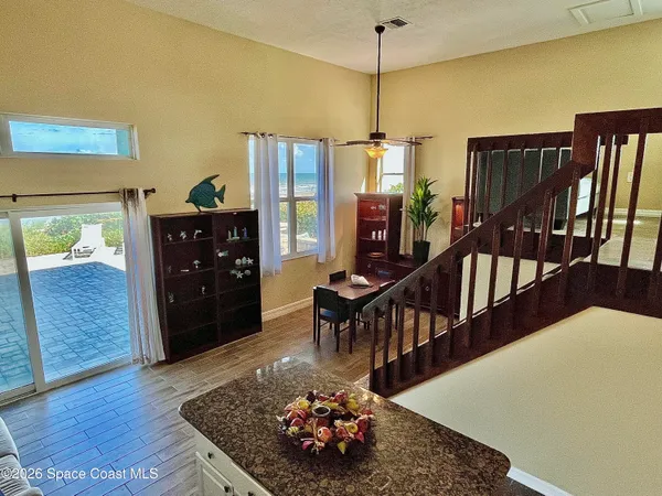 a living room with hard wood furniture and a rug