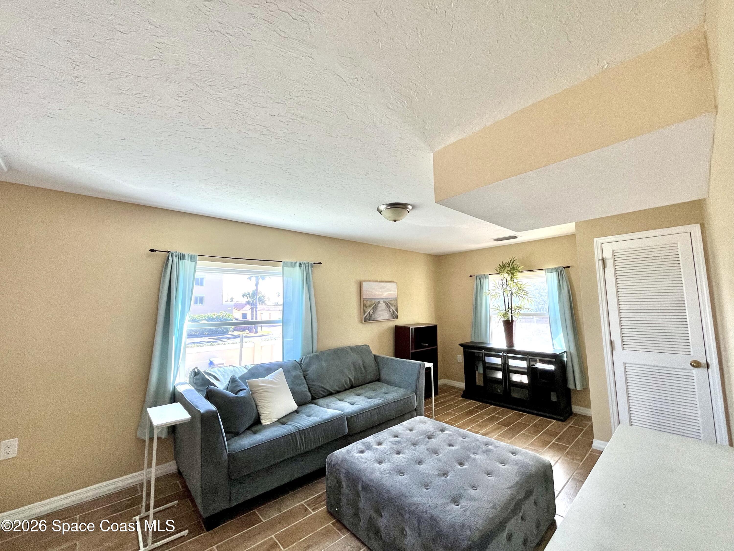 799 Shell Street Satellite Beach, FL 32937 - Photo 2 of 32 a living room with furniture and a window